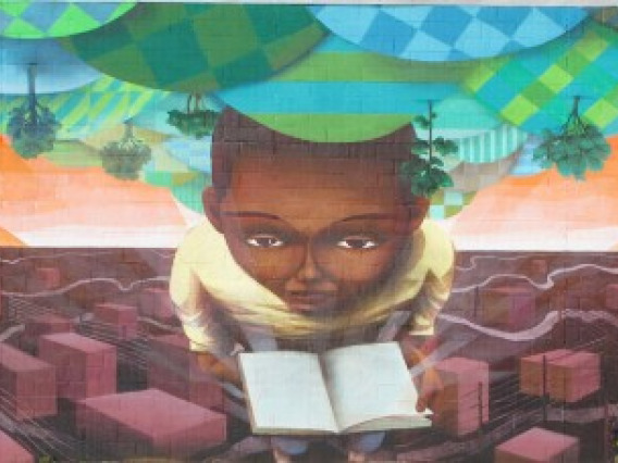 Mural of child reading a book