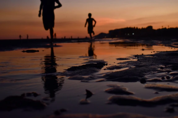 People running on a beach